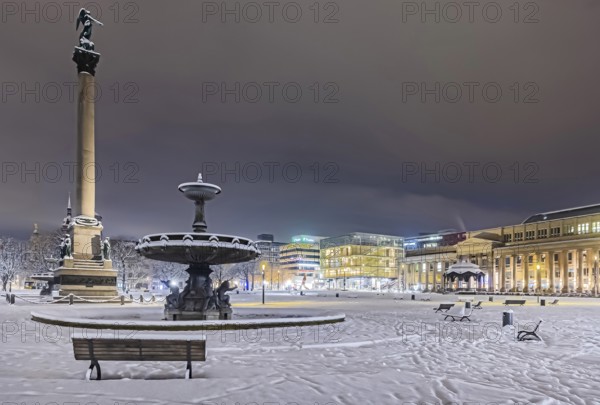 Winter in Stuttgart. It snowed overnight and the city is wintry white early in the morning. Palace Square with anniversary column, royal building and art museum. Stuttgart, Baden-Württemberg, Germany