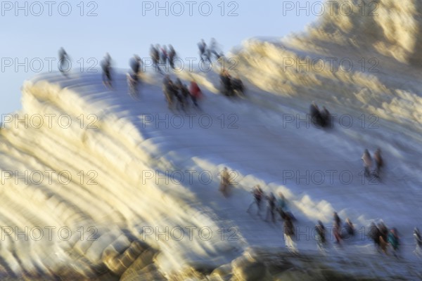 Terraced chalk cliffs Scala dei Turchi, anonymous walkers on Turkish steps, illustration, motion blur, Realmonte, Agrigento, Sicily, south coast, Mediterranean, Italy