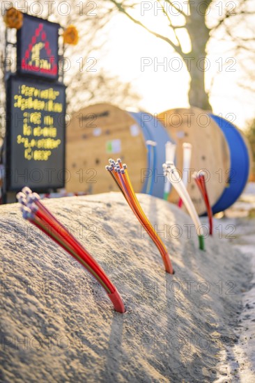 Various thin cables stick out of the ground of a construction site, fiberglass groundbreaking, Freudenstadt, Germany
