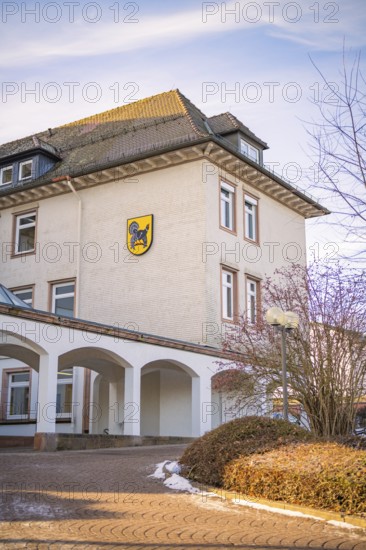 A traditional building with a coat of arms surrounded by winter landscape, fibreglass groundbreaking, Freudenstadt, Germany
