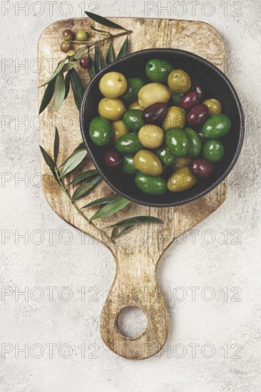 A mixture of olives, varieties of chalkidiki, Verdi giganti and Kalamata, in a bowl, top view, no people