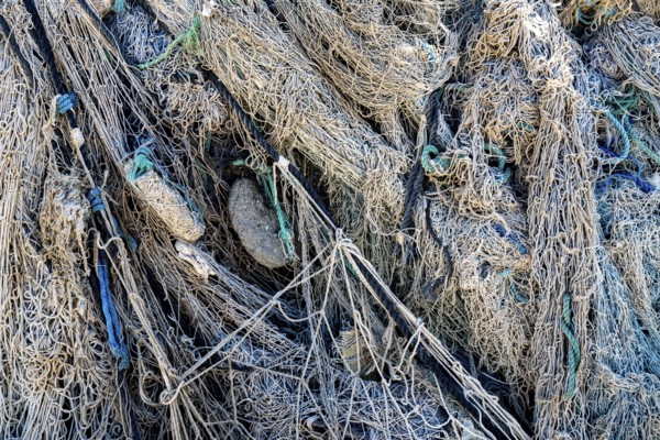 Close-up view of old fishing net hanging on boat, Oman