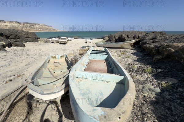 Old fishing boats, fishing village with boats on the beach, near Ras Madrakah, Oman