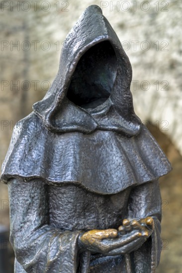 Monk sculpture, one of three bronze statues of faceless monks at the Danish King's Garden in the Old Town of the city Tallinn, Harju County, Estonia