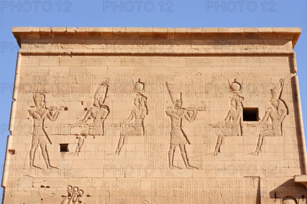 Relief of the king in front of the gods Osiris and Isis, Temple of Philae, UNESCO World Heritage Site, Agilkia Island, Aswan, Nubia, Egypt