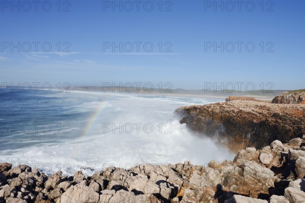 Surf with rainbow on the rocky coast, Carrapateira, Parque Natural do Sudoeste Alentejano e Costa Vicentina, Algarve, Portugal