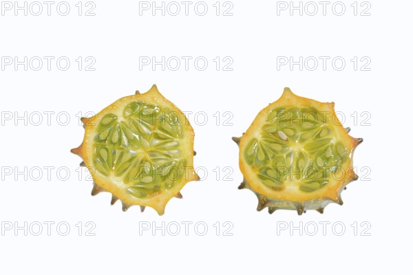 Horned cucumber, kiwano or horned melon (Cucumis metuliferus), sliced fruit on a white background, native to Africa