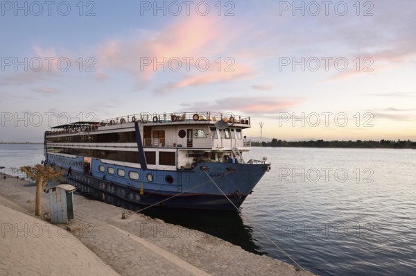 Nile cruise ship at a pier at dawn, Esna, Egypt