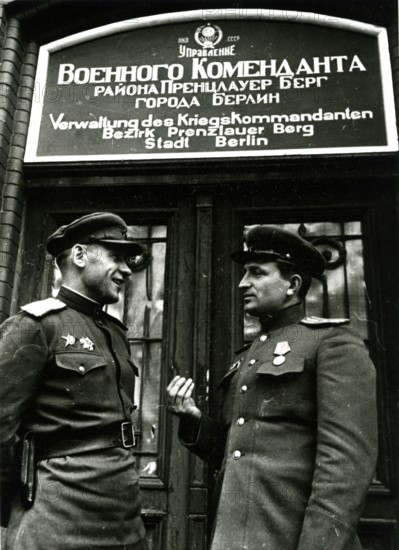 Two Soviet soldiers in front of the administration of the war commander for the district of Prenzlauer Berg, June 1945, Berlin, Germany