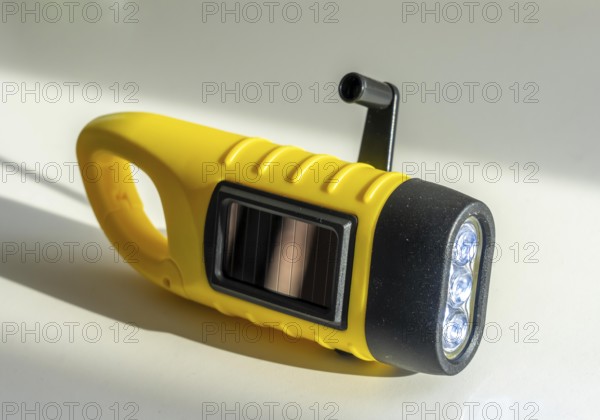 Crank operated flashlight, by turning the crank, we generate electricity in a dynamo, which charges a battery in the flashlight, in addition a small solar module to generate electricity from sunlight, for emergency preparedness in the event of a power failure, blackout, energy supply