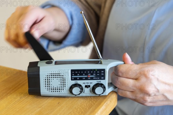 Radio with crank mode, by turning the crank we generate electricity in a dynamo, which charges a battery in a flashlight, in addition a small solar module to generate electricity from sunlight, for emergency preparedness in the event of a power failure, blackout, energy supply