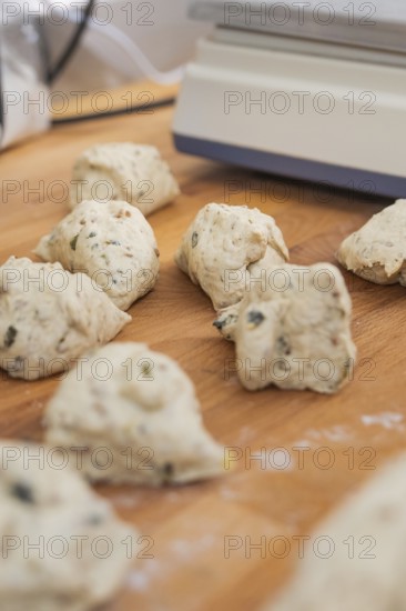 Several small pieces of dough lie on a wooden table to prepare, bake rolls, Haselstaller Hof, Gechingen, Germany