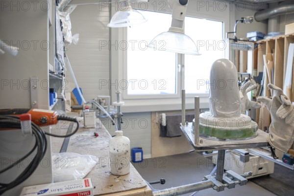 Workshop area with plaster and tools for making prostheses under lamps, medical supply store