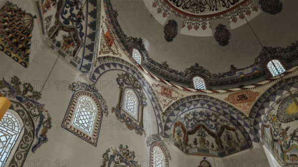 A magnificently decorated interior of a dome with rich ornaments and light-filled windows, Prizren, Kosovo