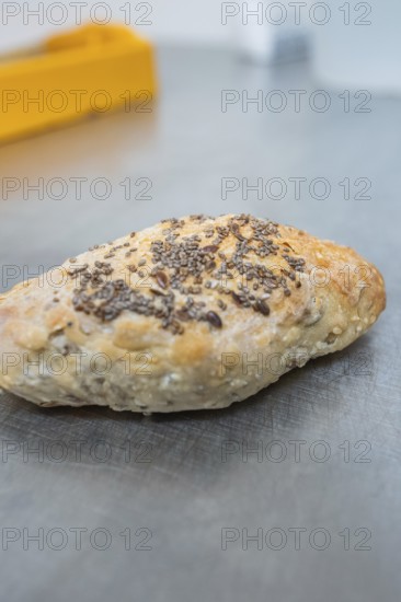 Crispy baked roll with seeds on a metal surface, bake rolls, Haselstaller Hof, Gechingen, Germany