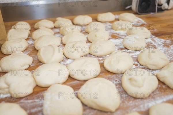 Many pieces of dough on a floured wooden board, ready for further preparation, bake rolls, Haselstaller Hof, Gechingen, Germany