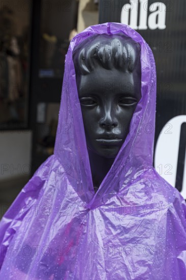 Window mannequin with rain cape in rain, Krakow, Poland
