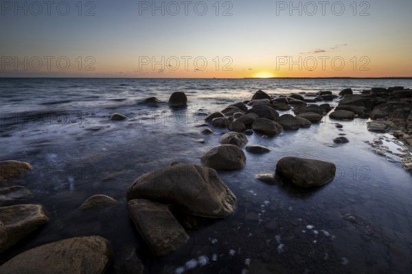 Rocks in the sea at sunset at Trönninge Stranden, Halmstad, Sweden