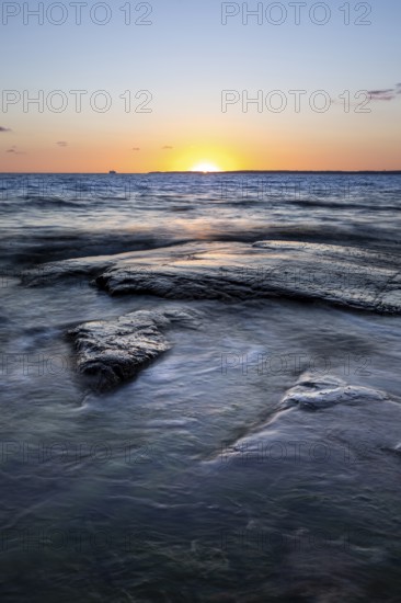 Rocks in the sea at sunset at Trönninge Stranden, Halmstad, Sweden