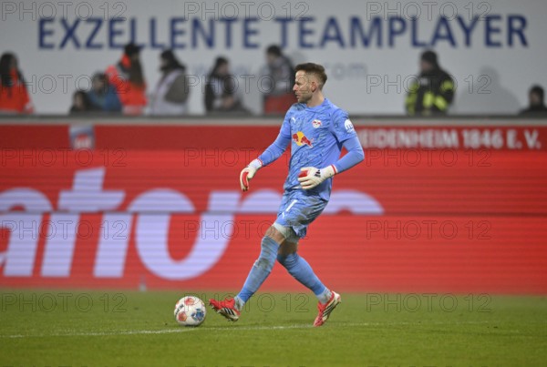 Goalkeeper Peter Gulacsi RasenBallsport RB Leipzig RBL (01) Action on the ball in the background perimeter advertising EXCELLENT TEAM PLAYER Soccer Bundesliga, Voith-Arena, Heidenheim, Baden-Württemberg, Germany
