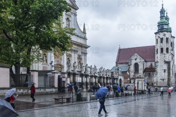 Sculptures of saints in front of St. Peter and Paul Church, St. Andrew's Church on the right, Krakow, Poland