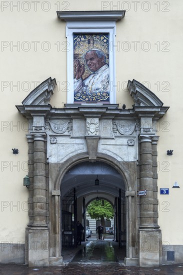 Mosaic portrait of Pope John Paul II above an entrance portal, Krakow, Poland