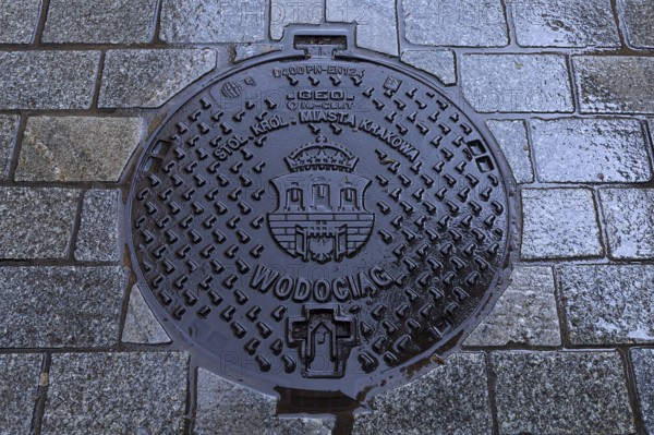 Manhole cover with the coat of arms of Krakow, Krakow, Poland