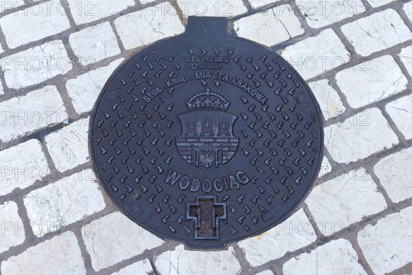 Manhole cover with the coat of arms of Krakow, Krakow, Poland