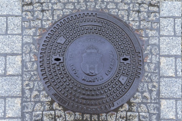 Manhole cover with the coat of arms of Krakow, Krakow, Poland