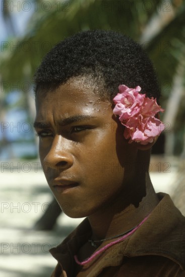 Boy with flowers behind left ear, Tavewa Island, Yasawa archipelago, Fiji