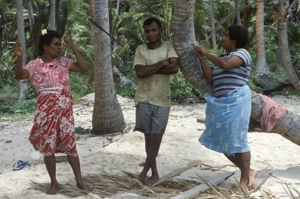 Local 2 woman and a man standing on the beach, Tavewa island, Yasawa archipelago, Fiji