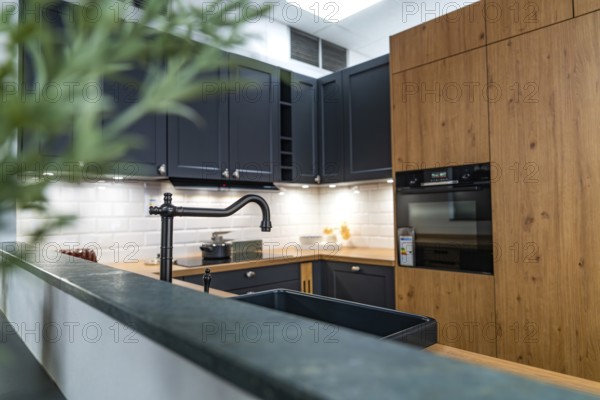 Modern kitchen with wooden surfaces and elegant black faucet