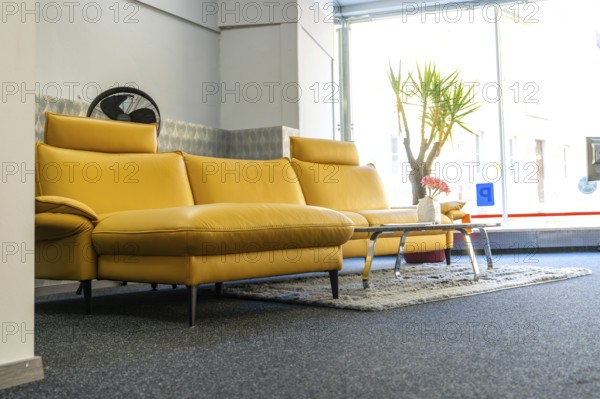 Modern living room with yellow sofa and window front, cozy atmosphere