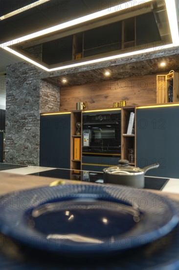 Detail of a modern kitchen with brick wall and elegant decoration