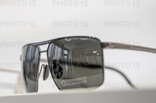 Close-up of sunglasses with mirror reflection in glass, optician, Pforzheim