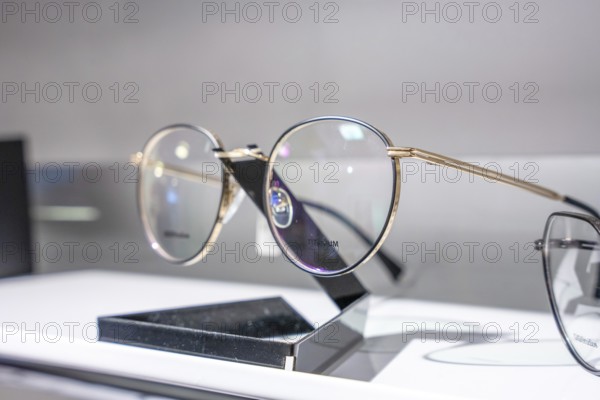 Close-up of modern round glasses on a simple stand, optician, Pforzheim