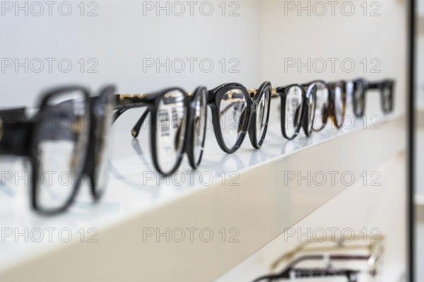 Row of eyeglass frames on a shelf in an optician's shop, optician, Pforzheim