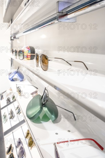 Modern eyeglass rack with a selection of sunglasses in a bright showroom, optician, Pforzheim
