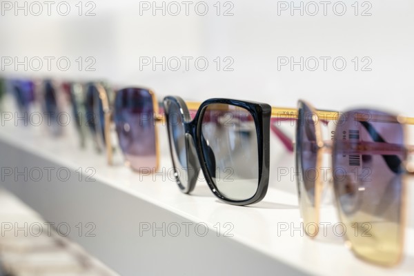 Set of sunglasses in different colors on a shelf, optician, Pforzheim