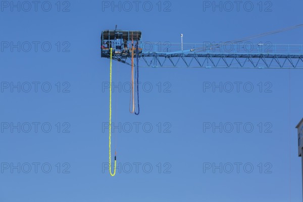 Montreal Bungee Tower installation with dangling long yellow elastic bungee jumping cord, Old Port of Montreal, Quebec, Canada