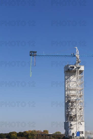 Montreal Bungee Tower with dangling long yellow elastic bungee jumping cord and man ready to jump, Old Port of Montreal, Quebec, Canada