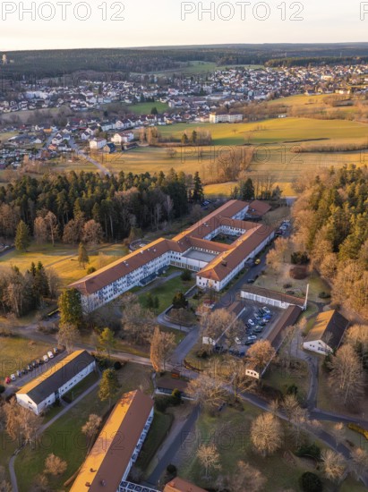 A bird's-eye view of a village with extensive fields and buildings at winter sunset, Rehab Clinic, Schömberg, Black Forest, Germany
