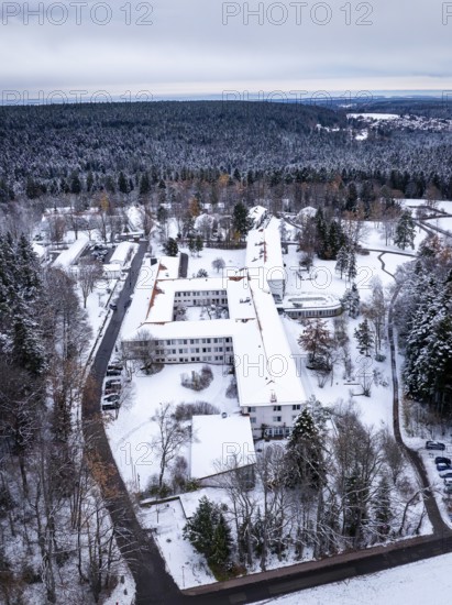 A snow-covered building in the middle of a wooded winter landscape mountain, Rehab Clinic, Schömberg, Black Forest, Germany