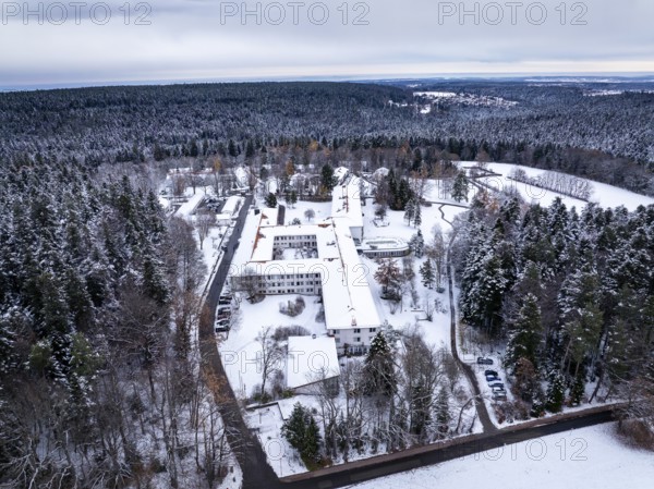 Snowy landscape with buildings surrounded by thick forests and a wide sky, rehab clinic, Schömberg, Black Forest, Germany