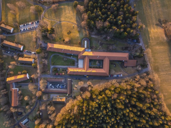 Bird's eye view of a sprawling complex with red roofs and forests, Rehab Clinic, Schömberg, Black Forest, Germany