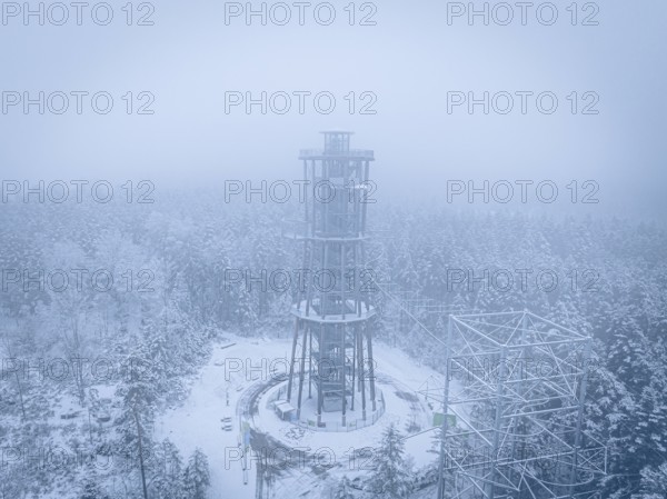 A lonely tower stands in a foggy, snowy forest, Himmelsglück observation tower with Flying Fox, Schömberg, Black Forest, Germany