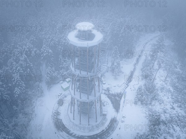 A bird's-eye view of an observation tower stands in a foggy winter landscape, Himmelsglück observation tower with flying fox, Schömberg, Black Forest, Germany