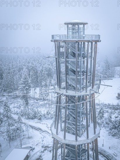 An observation tower towers over snow-covered forests in a foggy winter landscape, Himmelsglück observation tower with flying fox, Schömberg, Black Forest, Germany