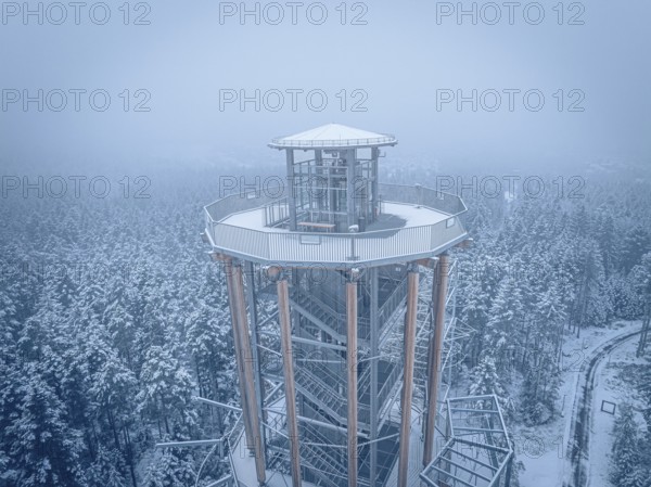 Snow-covered tower above a winter forest in fog, Himmelsglück observation tower with Flying Fox, Schömberg, Black Forest, Germany