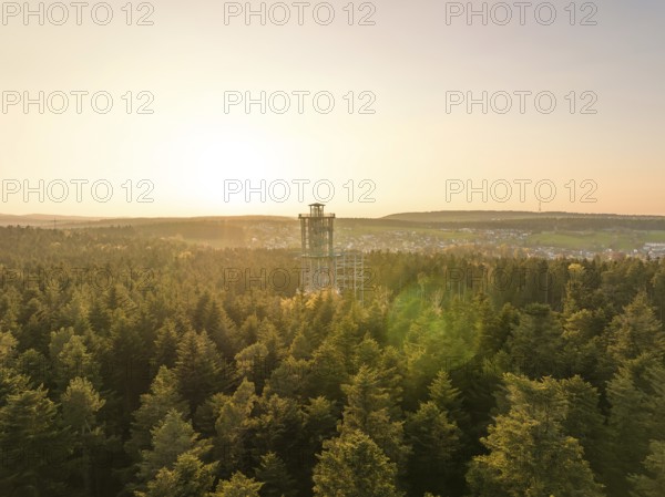 An observation tower rises above a green forest under a golden sunset, Himmelsglück observation tower with Flying Fox, Schömberg, Black Forest, Germany